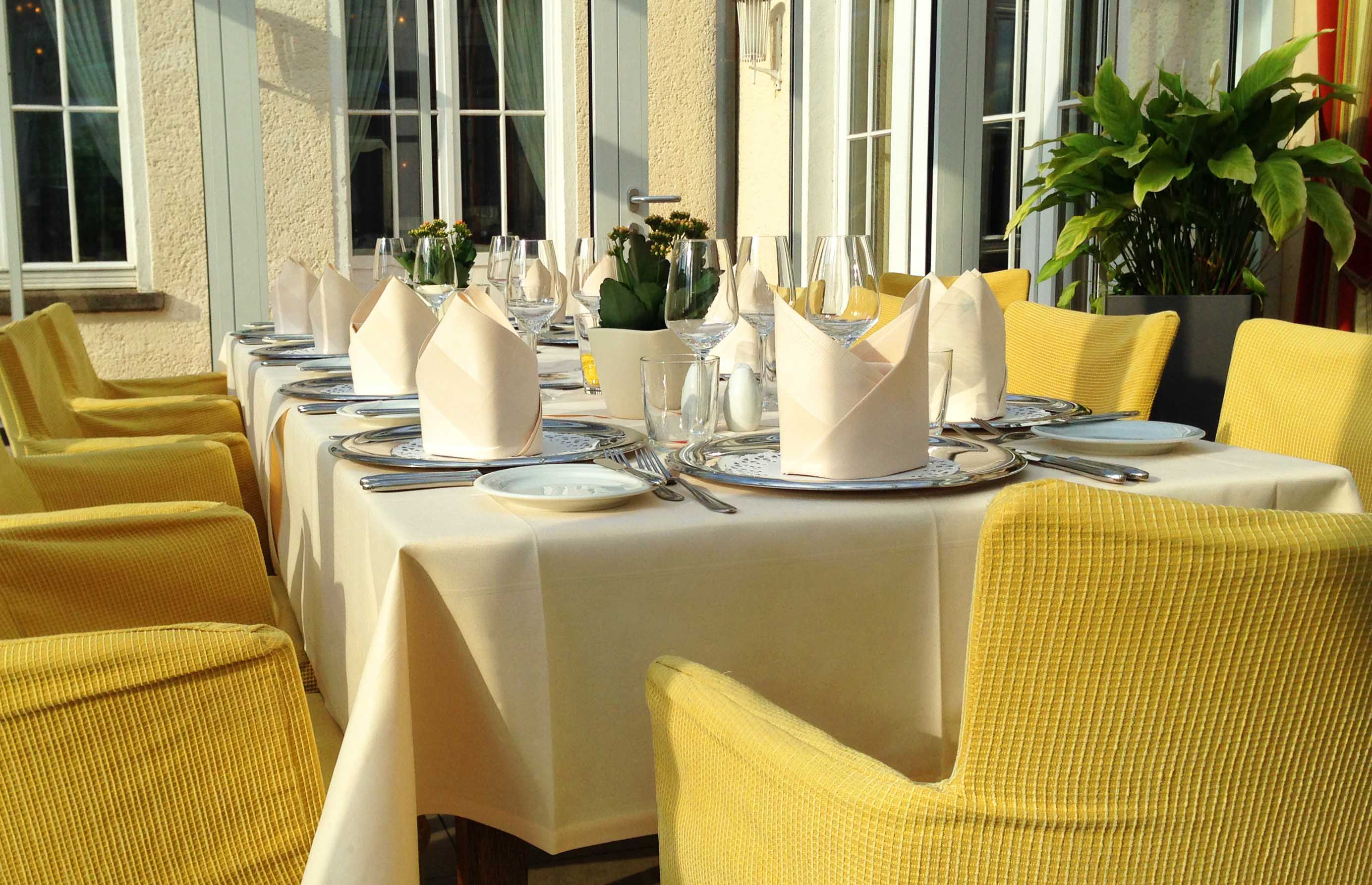 Beautifully set dining table with elegant tablecloth